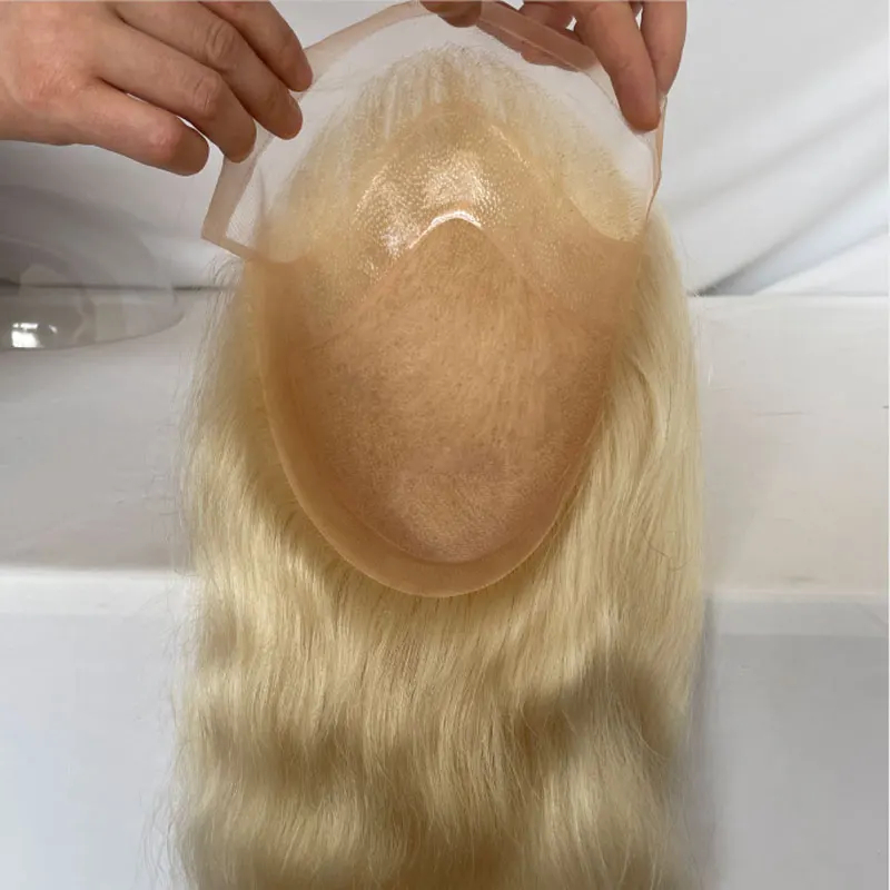 Blonde hair toupee with mesh base being applied on head